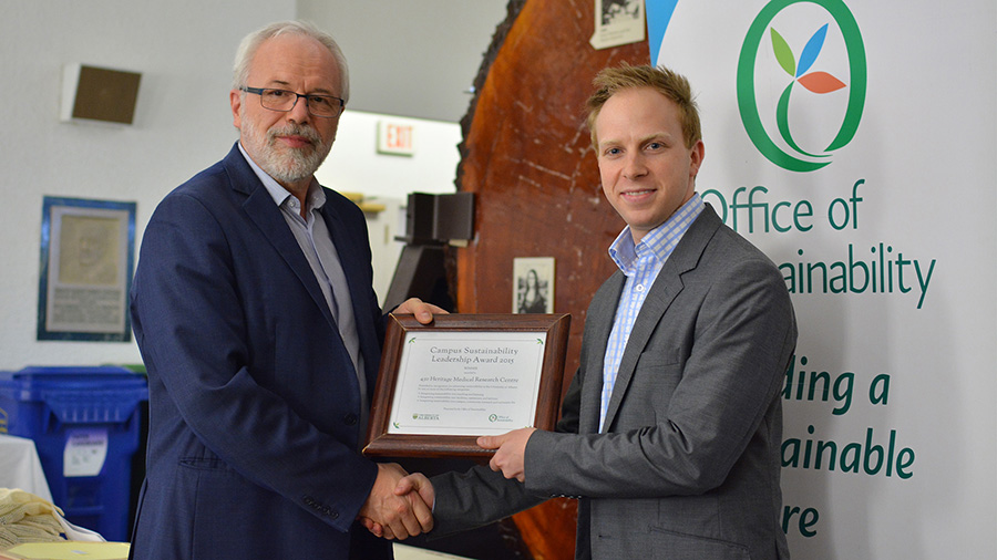 Jamie Boisvenue accepts the Sustainability Leadership Award on behalf of Jason Dyck's lab.