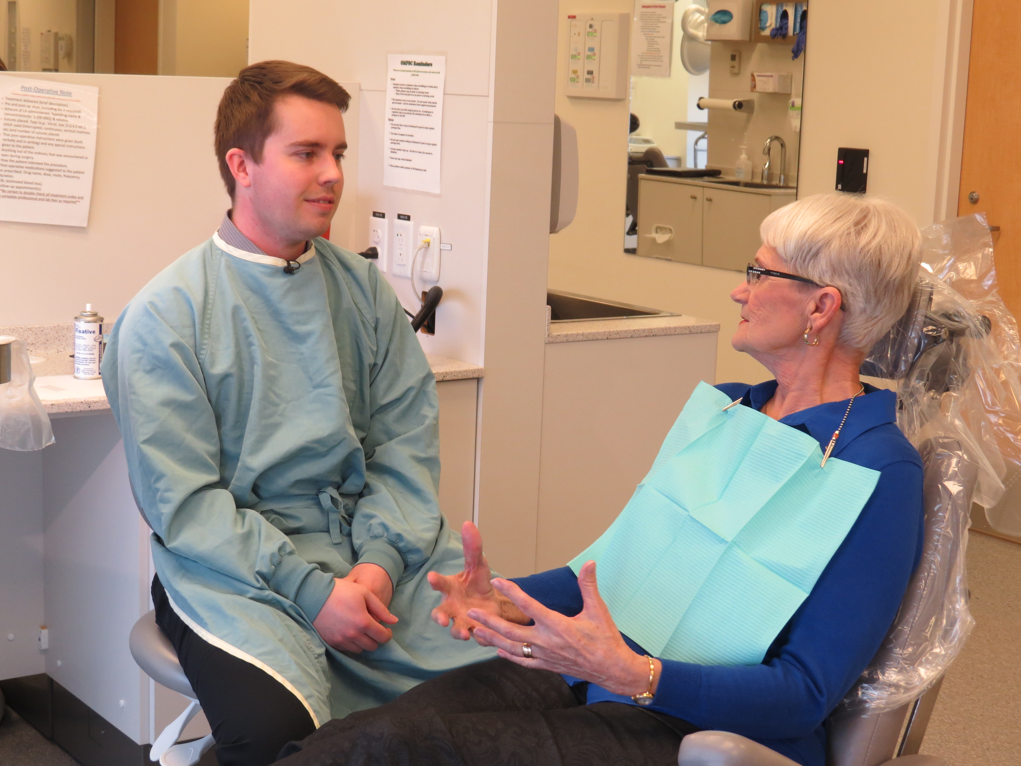 Reid Friesen, an Oral Medicine Program resident, speaks with patient Elizabeth LePage.